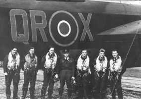 61 Sqn - photo of 7 aircrew members standing by the side of QR.X